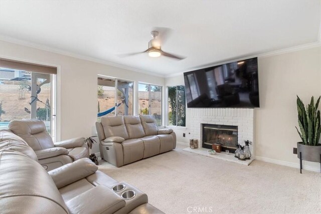 living room with ornamental molding, plenty of natural light, light carpet, and a fireplace