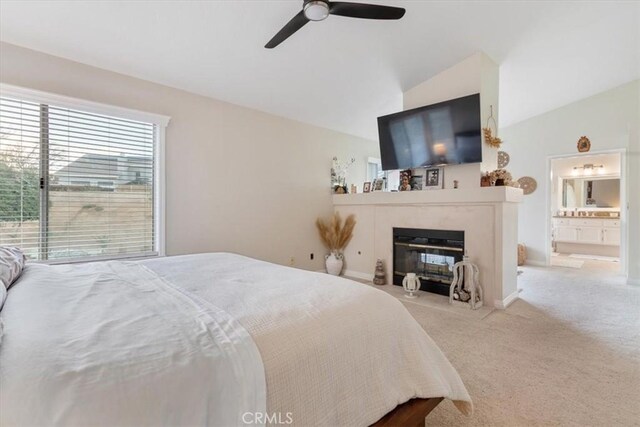 bedroom featuring vaulted ceiling, light colored carpet, and ceiling fan