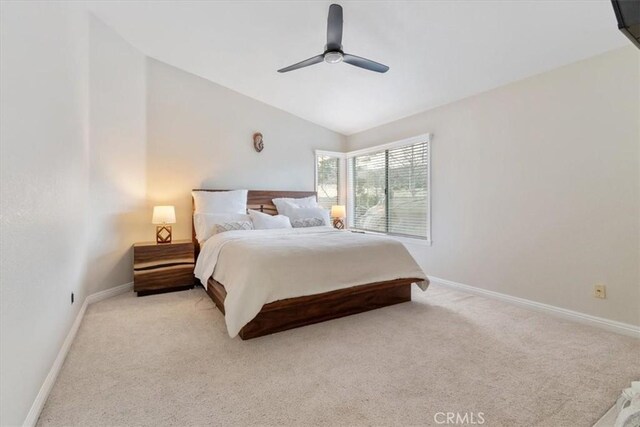 carpeted bedroom featuring ceiling fan and vaulted ceiling