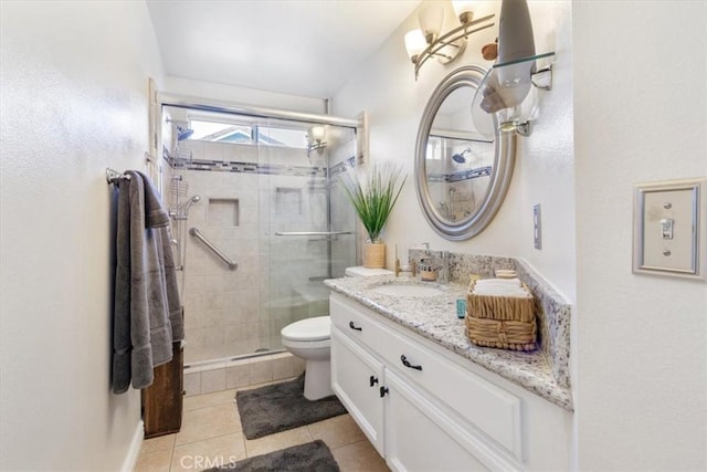 bathroom featuring vanity, toilet, an enclosed shower, and tile patterned flooring