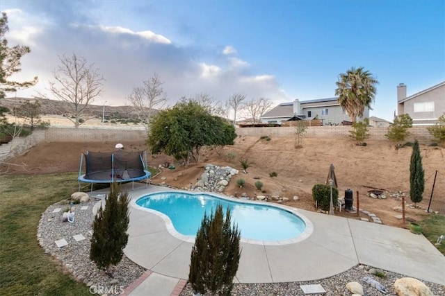 view of pool with a trampoline