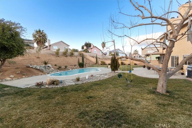 view of pool with a yard