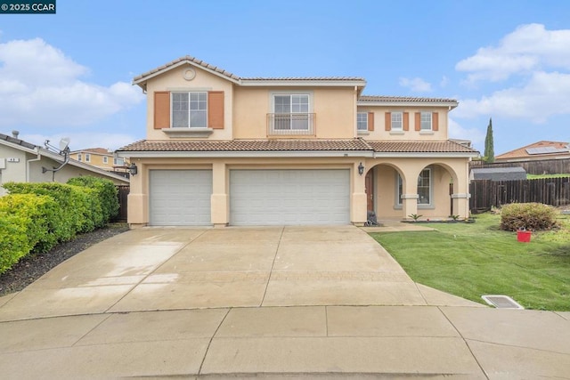 mediterranean / spanish-style home with a garage and a front yard