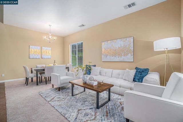 carpeted living room with an inviting chandelier