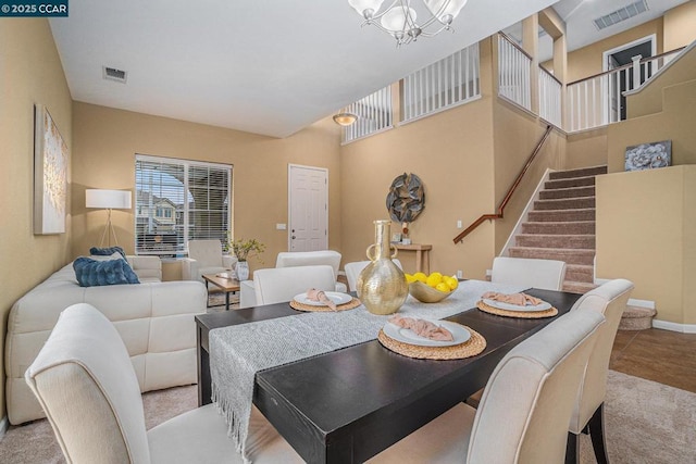 dining room with a high ceiling and an inviting chandelier