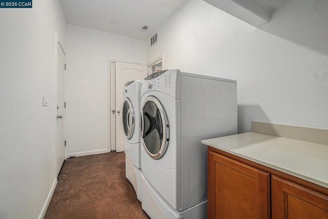 laundry area featuring cabinets and washer and dryer