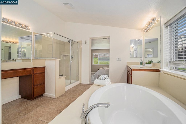 bathroom with lofted ceiling, vanity, plus walk in shower, and tile patterned flooring