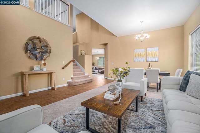 tiled living room featuring a chandelier and high vaulted ceiling