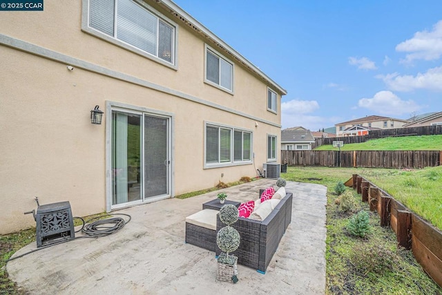 back of property featuring central AC unit, an outdoor living space, a lawn, and a patio