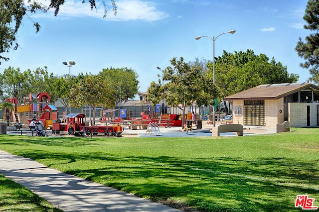 view of community featuring a lawn and a playground