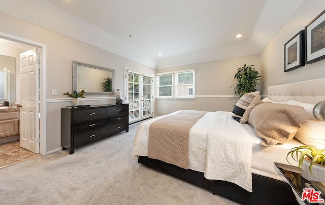 carpeted bedroom featuring connected bathroom