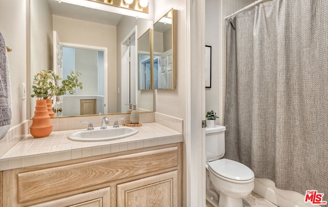 bathroom with vanity, a shower with shower curtain, and toilet