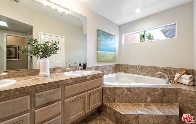 bathroom with vanity and tiled bath