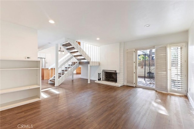 unfurnished living room featuring hardwood / wood-style flooring and a fireplace