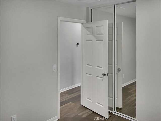 hall with dark hardwood / wood-style floors