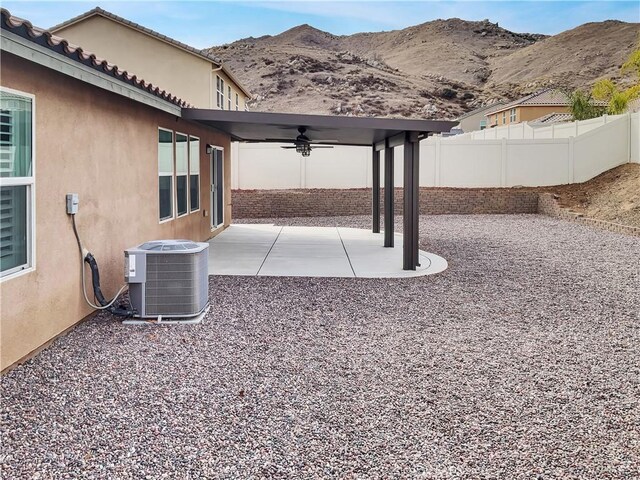 view of patio featuring a mountain view, ceiling fan, and central air condition unit