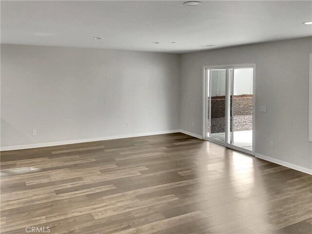 spare room featuring dark wood-type flooring