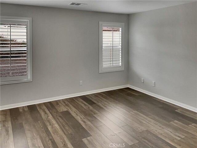 empty room featuring dark wood-type flooring