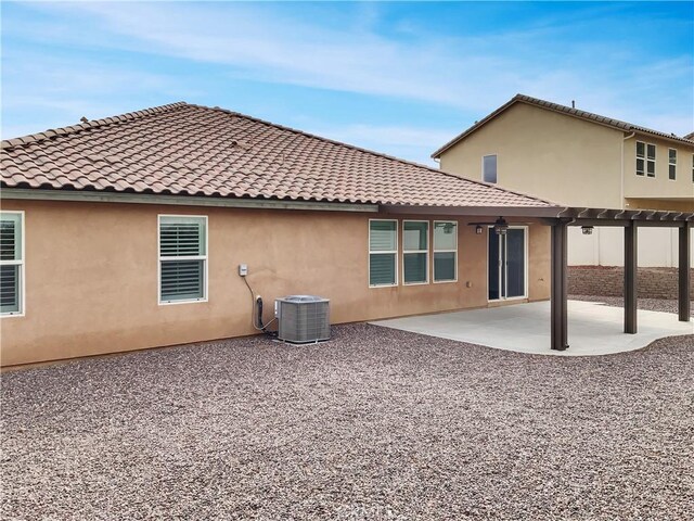 rear view of property with a patio and central AC