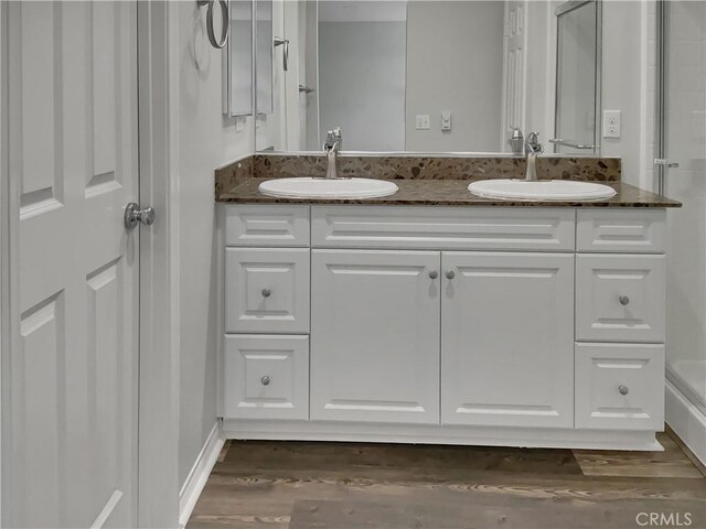 bathroom with vanity and hardwood / wood-style flooring