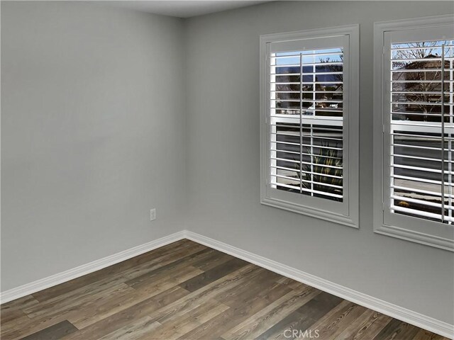 empty room with hardwood / wood-style flooring