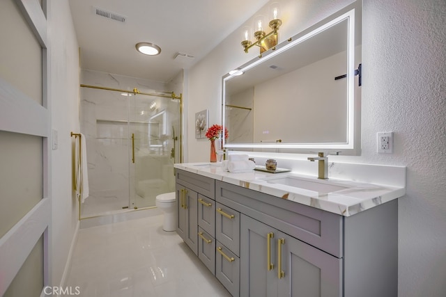 bathroom featuring an enclosed shower, vanity, and toilet