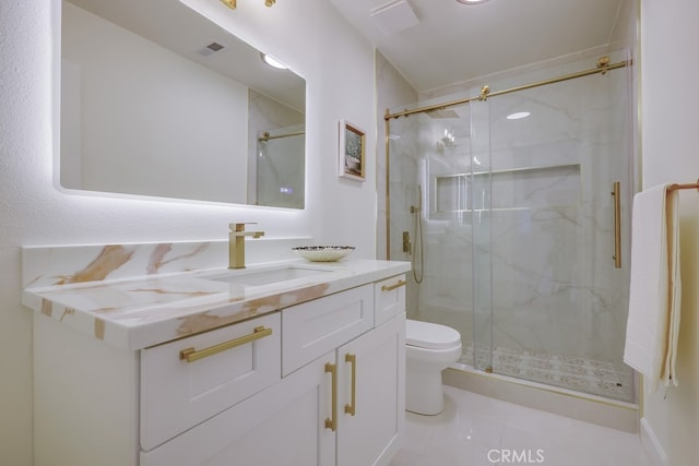 bathroom with walk in shower, vanity, and toilet