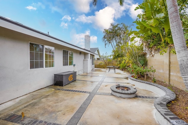 view of patio with an outdoor fire pit