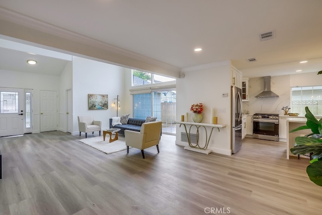 living room featuring ornamental molding and light hardwood / wood-style floors