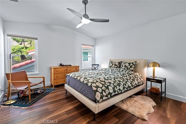 bedroom with dark hardwood / wood-style flooring, vaulted ceiling, and ceiling fan