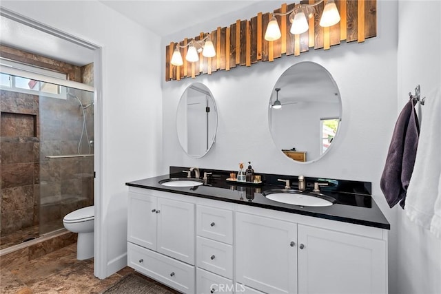 bathroom with vanity, plenty of natural light, an enclosed shower, and toilet