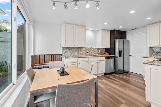 kitchen with white cabinetry, appliances with stainless steel finishes, and sink