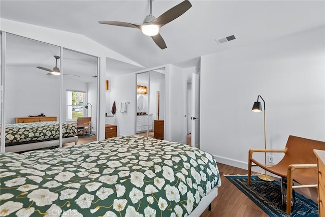 bedroom with lofted ceiling, hardwood / wood-style flooring, ceiling fan, and ensuite bathroom