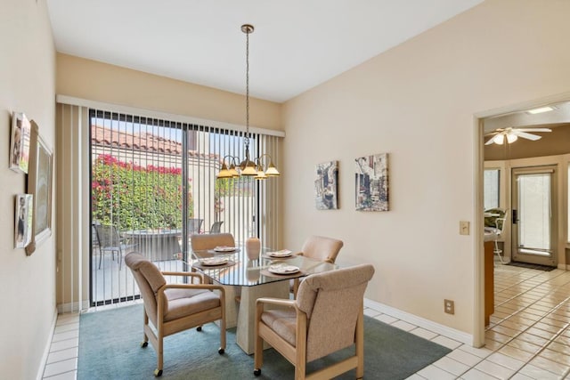 dining room with ceiling fan with notable chandelier and light tile patterned floors