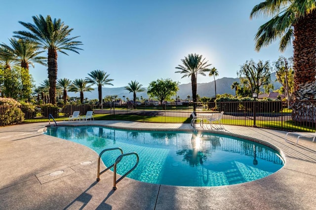 view of pool with a mountain view and a patio