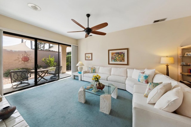 living room with ceiling fan and carpet