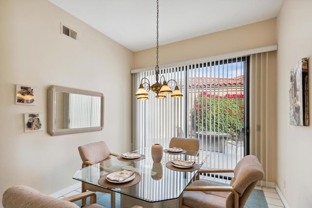 tiled dining space with a notable chandelier