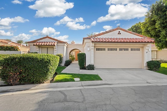 mediterranean / spanish-style home featuring a garage