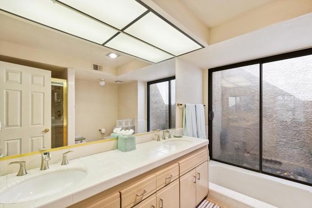 full bathroom with enclosed tub / shower combo, vanity, and toilet