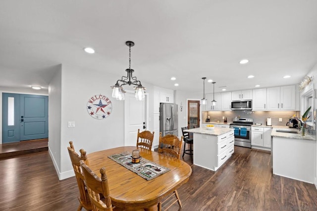 dining room with sink and dark hardwood / wood-style flooring