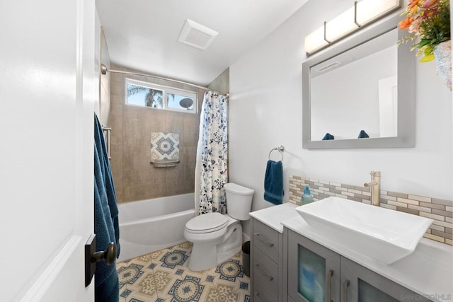 full bathroom with tile patterned floors, toilet, tasteful backsplash, vanity, and shower / bath combo with shower curtain