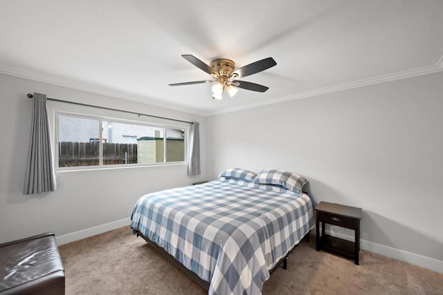 bedroom featuring ornamental molding, light carpet, and ceiling fan