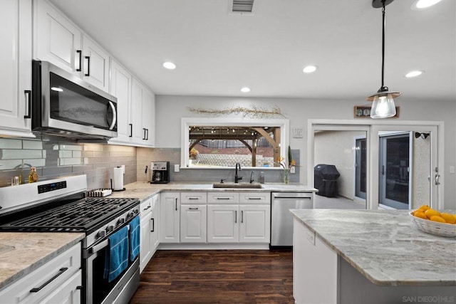 kitchen with white cabinetry, sink, and appliances with stainless steel finishes