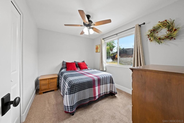 bedroom featuring light colored carpet and ceiling fan