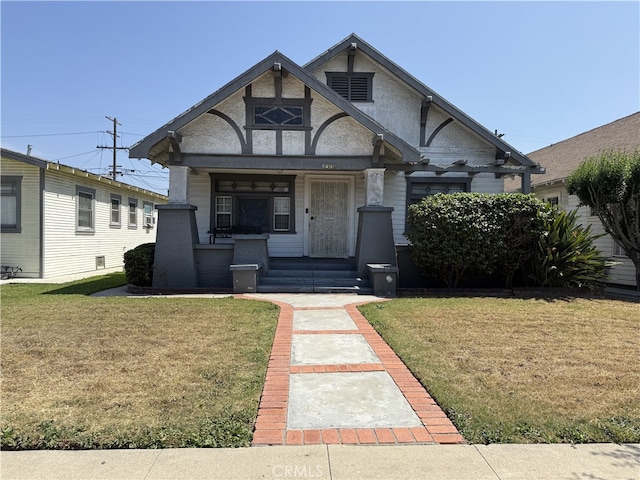 1490 W 51st St, Los Angeles, CA 90062 - english style home featuring covered porch and a front lawn