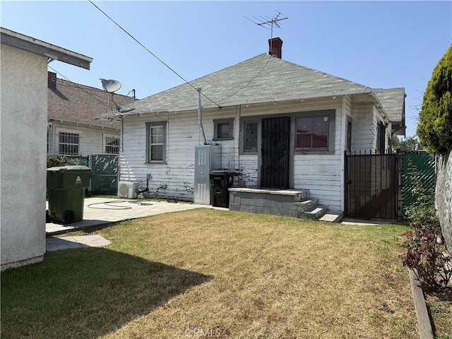 1490 W 51st St, Los Angeles, CA 90062 - rear view of property featuring a gate and a chimney