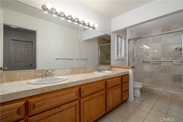 bathroom featuring an enclosed shower, vanity, tile patterned floors, and toilet