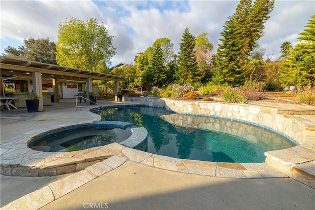 view of pool featuring a patio and an in ground hot tub