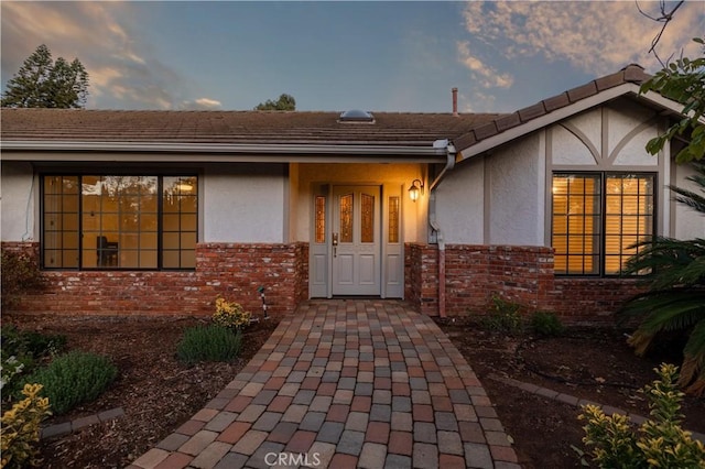 view of exterior entry at dusk