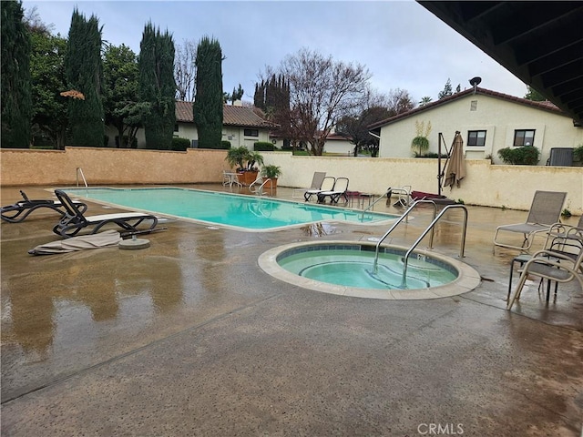 pool featuring central AC, a patio area, fence, and a hot tub